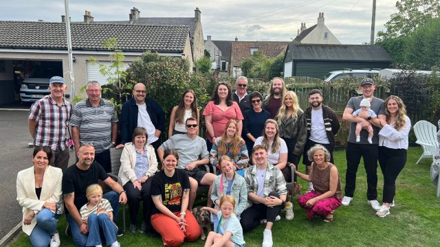 The 1Let team and families enjoying the 2025 summer BBQ together in the garden.