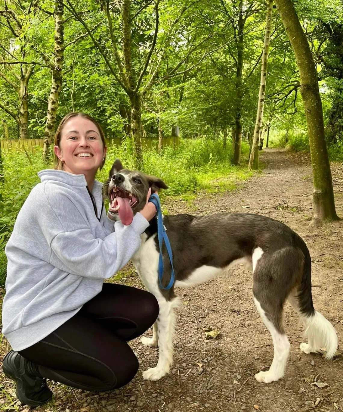 Tina enjoying a peaceful woodland walk with her dog - one of her favourite ways to switch off outside of work.